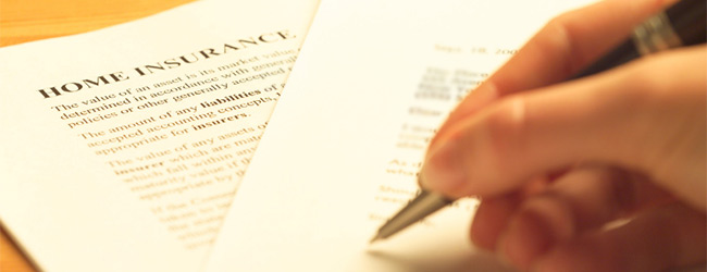 Person signing a home insurance document