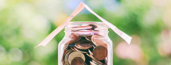 Coins in a jar with a folded paper over it